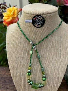 Aubrey - Emerald Elegance Stunning Green Beaded Necklace. Necklace showcases a beautiful array of greens, from deep forest to light lime.